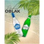 Zwei Flaschen bulgarischer Spirituosen – Mastika Peshtera (weiß) und Menta Peshtera (grün) – liegen am tropischen Sandstrand mit Palmenblättern und türkisblauem Wasser, dazu der Schriftzug „Paket OBLAK“.